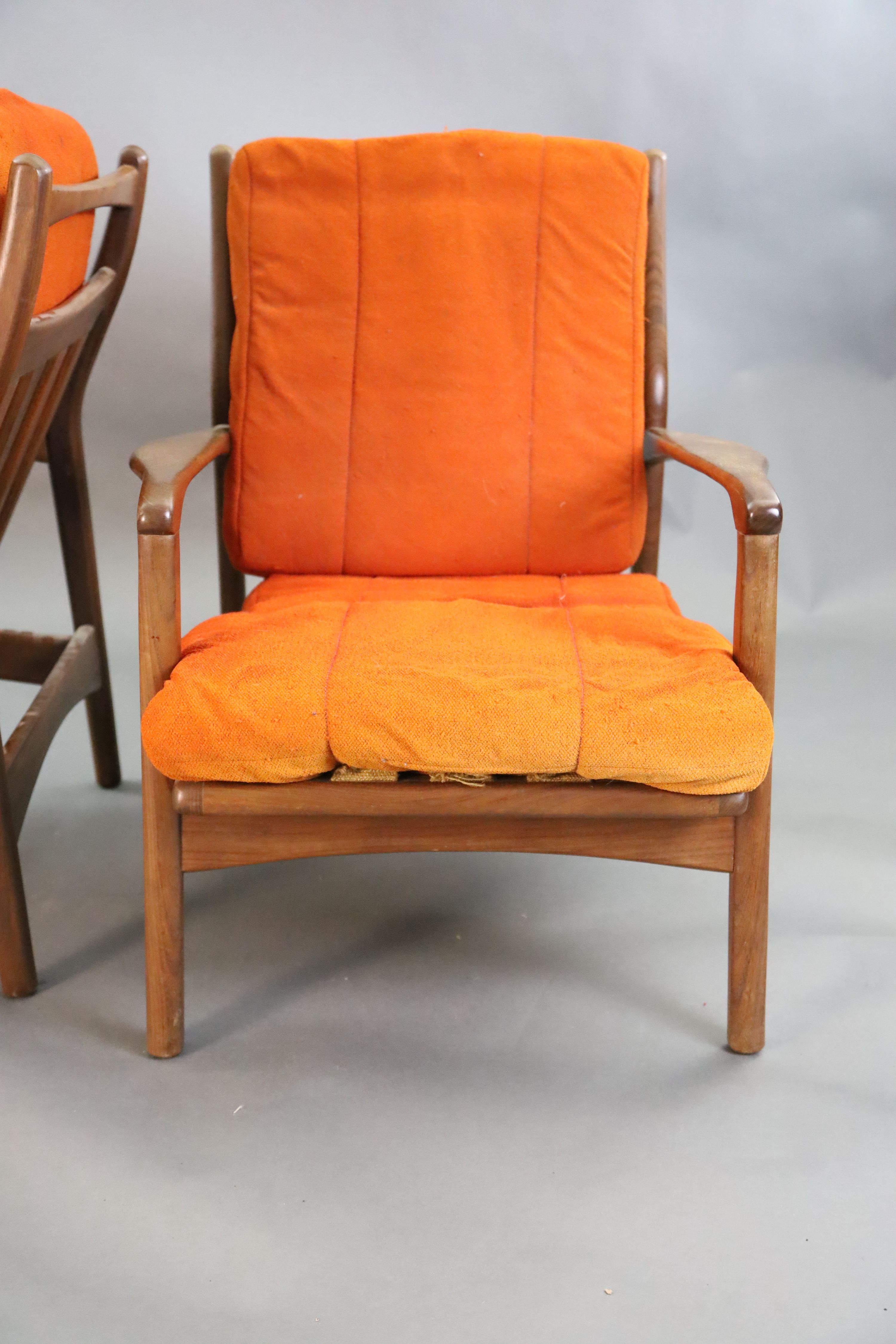 A pair of mid century Danish teak armchairs, W.2ft 2.5in. D.2ft 10in. H.2ft 8in.